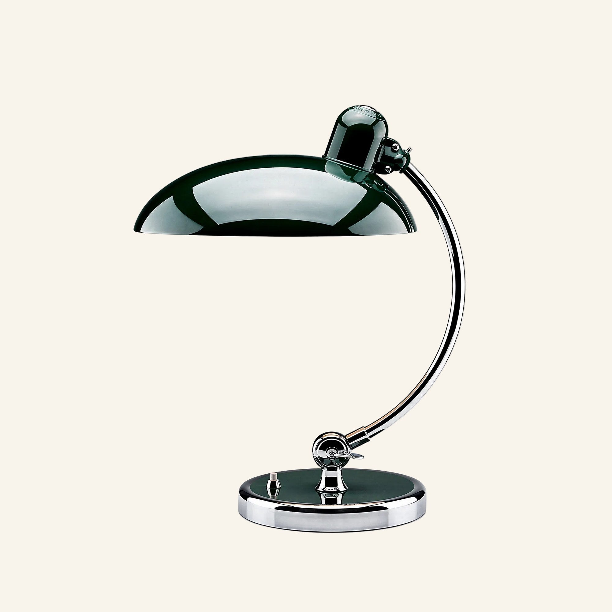 Dark forest-green lacquered dome shade above a curved chrome arm and round metal base, studio shot of the Bauhaus table lamp.
