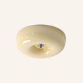 Rounded cream opal glass flush mount with chrome centre cap, photographed on a soft ivory studio backdrop showing its pudding silhouette.