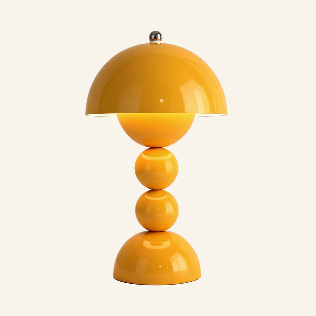 Mustard yellow mushroom table lamp with chrome finial and stacked sphere stem, glossy ABS body shown lit on a neutral studio background