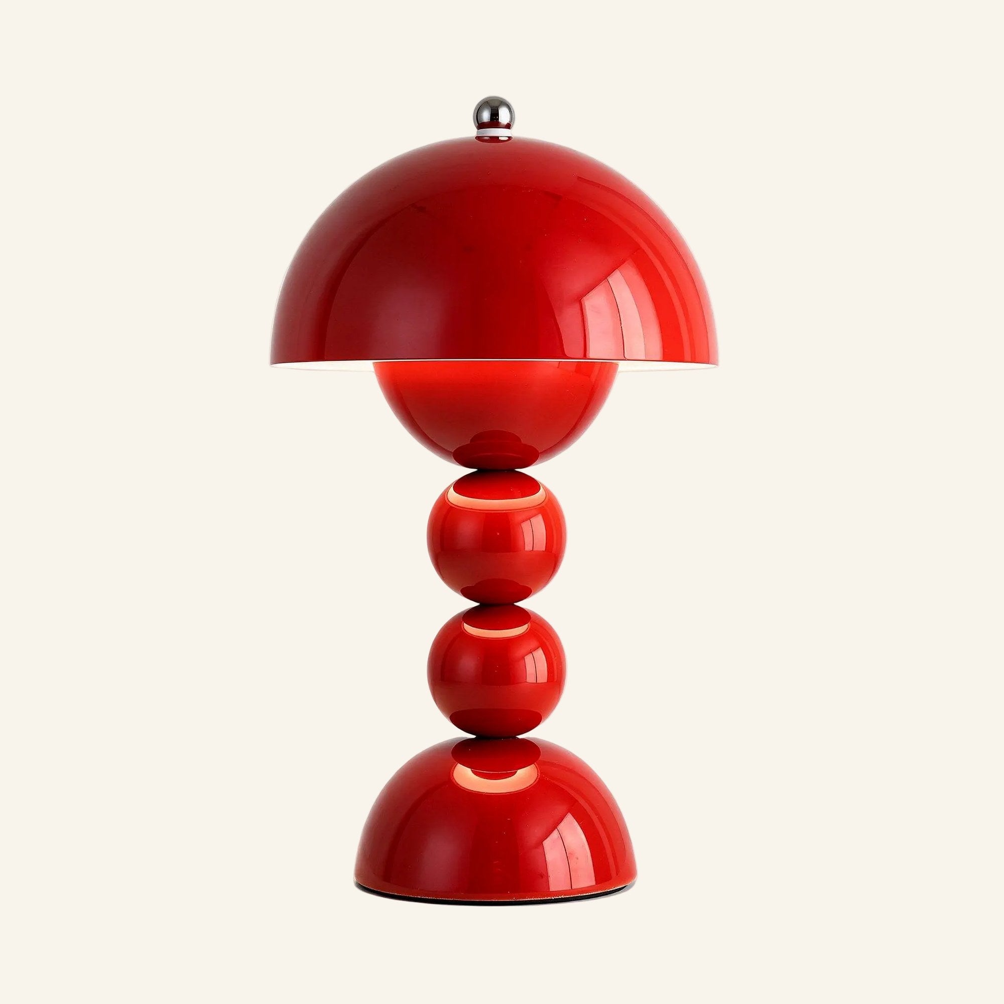 Bright red colourway of the rechargeable mushroom dome lamp, glossy lacquered ABS with chrome topper, shown lit against cream backdrop