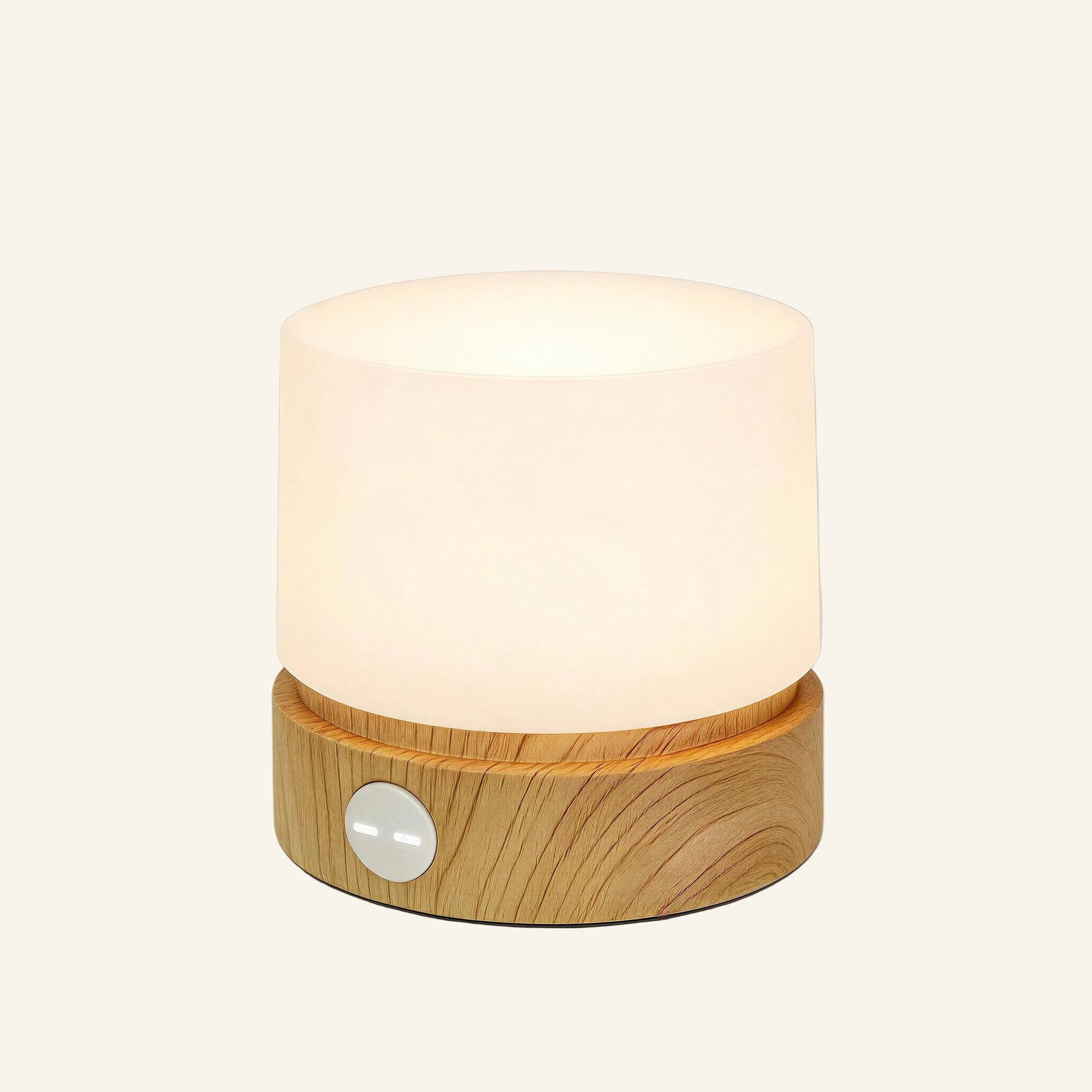 Close-up of the rechargeable cylindrical table lamp showing the frosted shade, oak-toned wooden base and round amber side button