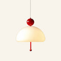 Dome pendant lamp with white opal glass shade, glossy red lacquered ball cap and matching red pull cord on cream studio backdrop