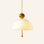 Brass colour variant of the dome pendant, polished gold ball cap and slender pull rod paired with a glowing opal glass shade