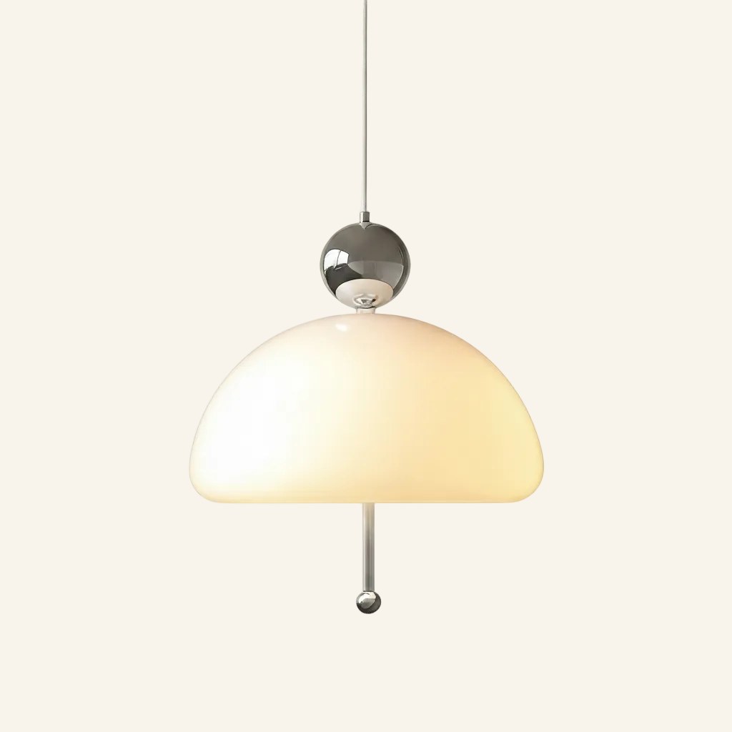 Chrome finish version of the pendant lamp, mirror-polished silver ball cap and pull cord above a warmly lit opal dome