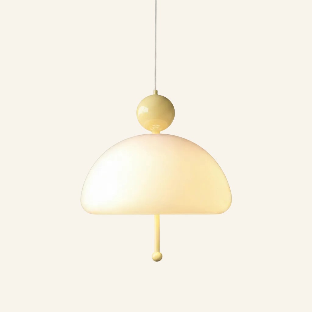 Pastel yellow colourway of the pendant, soft buttery ball cap and pull cord contrasting the milky glass dome shade