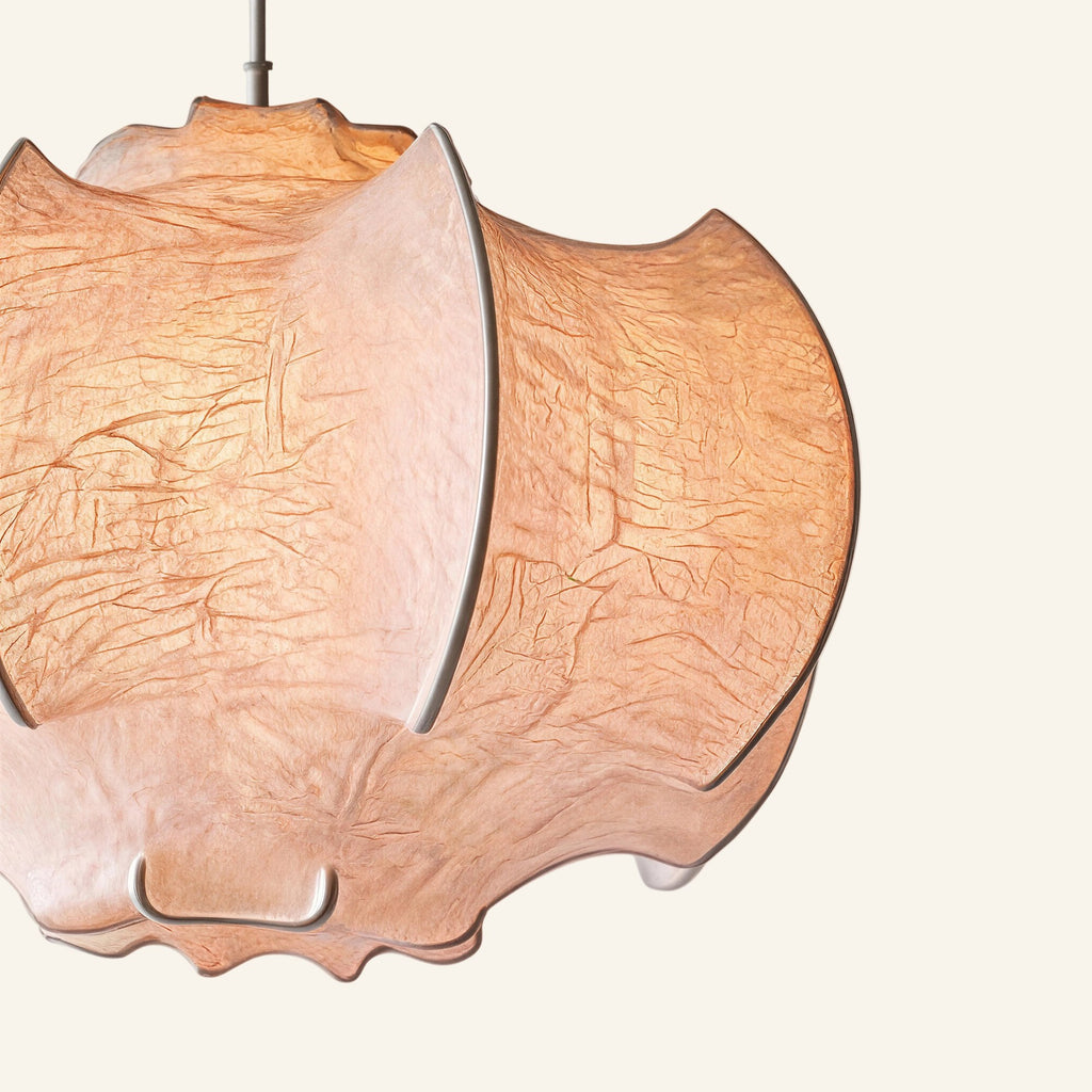 Close-up of draped faux-silk fabric showing creased linen-paper texture and visible iron ribs forming the cocoon pendant shade's petal structure