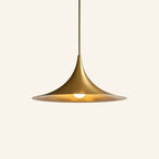 Brushed brass finish of the trumpet dome pendant, golden interior reflecting the lit bulb beneath the wide flared brim.