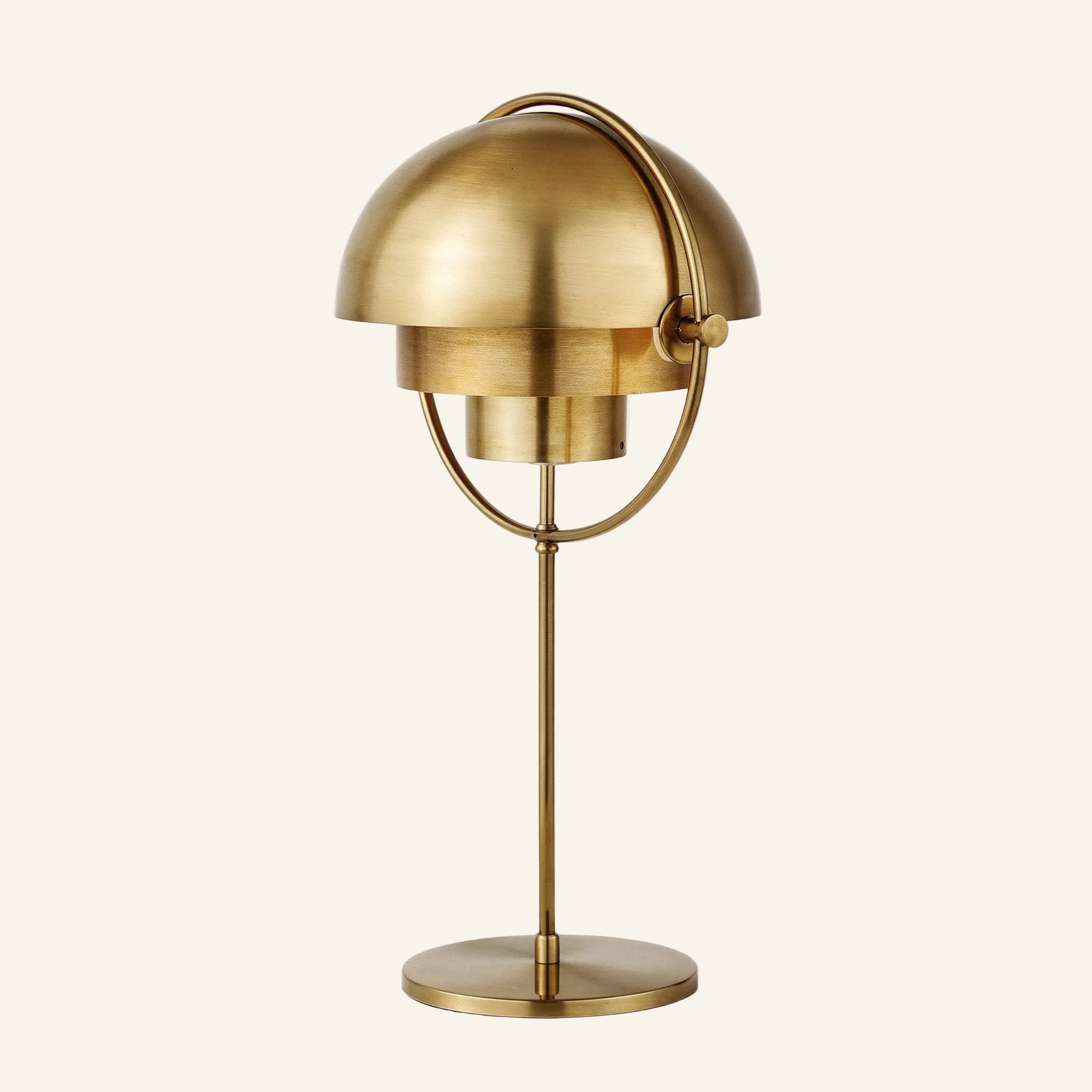 Alternate brass-shade version of the dual-dome table lamp, warm metallic finish across both hemispherical shades, ring, stem and round base.