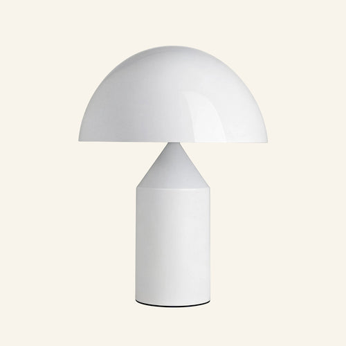 Glossy white mushroom dome table lamp with cylindrical metal base and inner cone reflector on cream studio backdrop