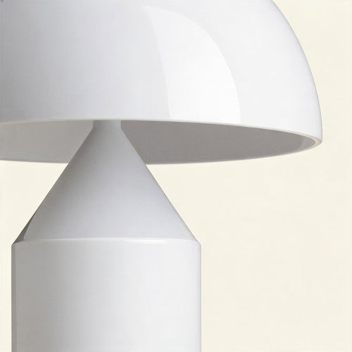 Close-up of the lacquered dome shade meeting the conical reflector above a smooth cylindrical metal base