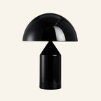 Black lacquered version of the dome table lamp showing the mushroom silhouette and reflective metal finish