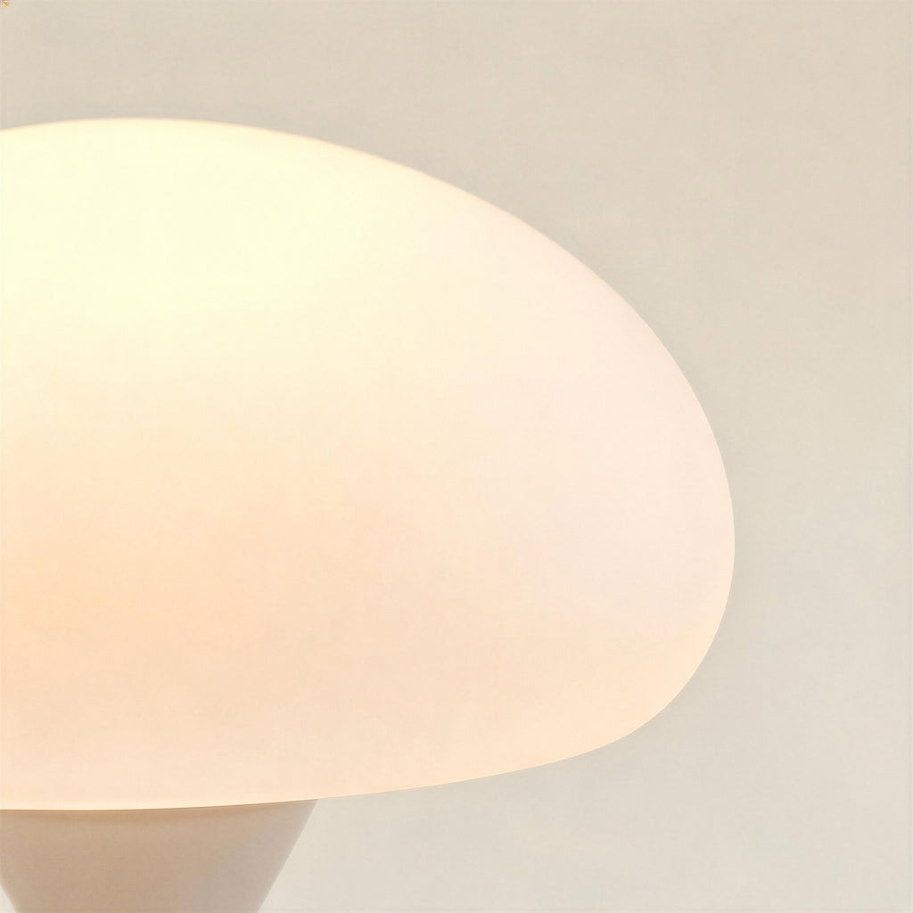 Close-up of the frosted opal glass dome shade, showing soft warm light diffusion and the smooth curved underside edge