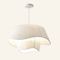 Two-tier cream pleated silk pendant lamp with wavy hem and white ceiling canopy, shown on a soft cream studio background