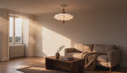 Cinematic video of a ruffled cream cloud semi-flush ceiling light with walnut wood beads glowing softly in a sunlit living room.