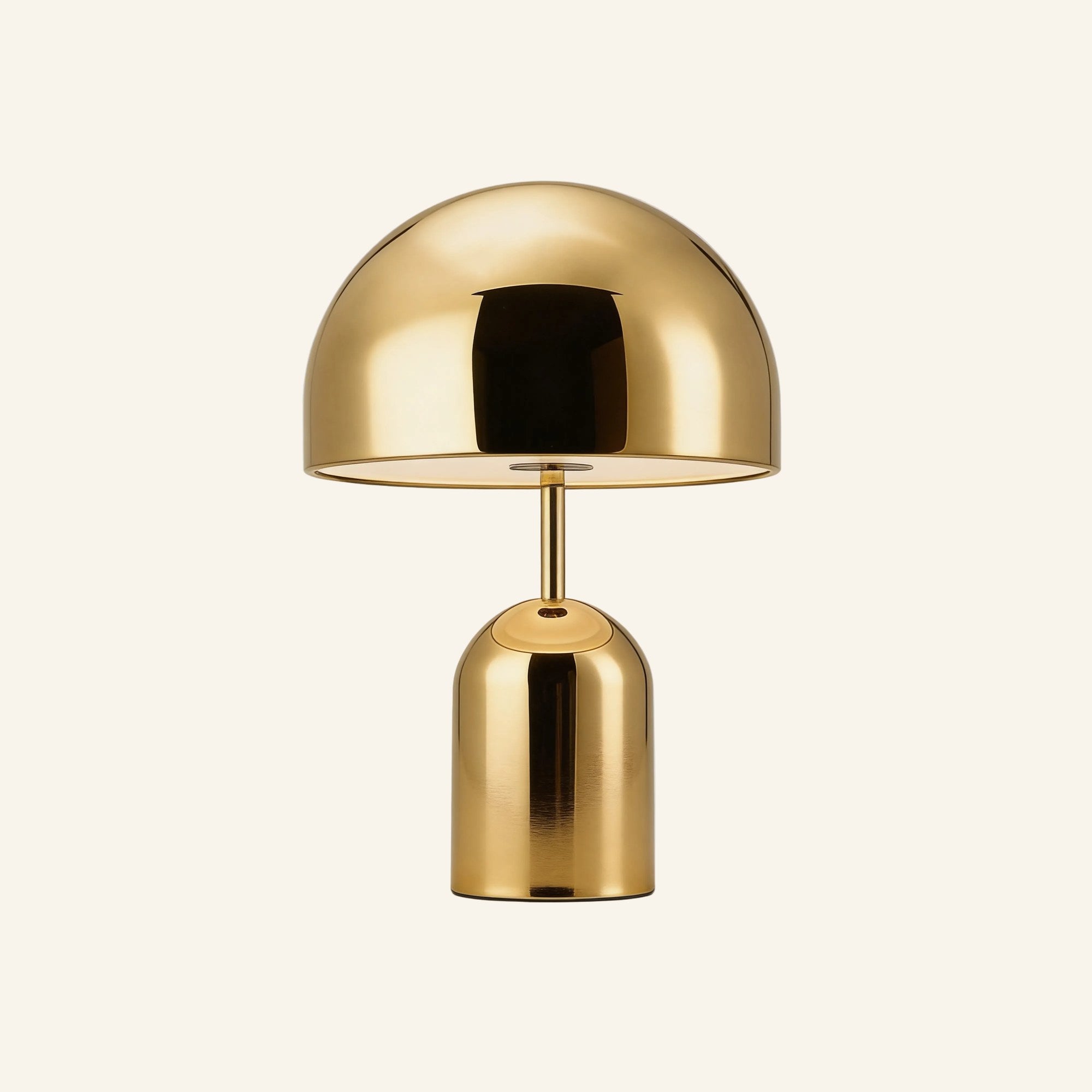 Brass-finish variant of the dome table lamp on cream background, golden polished shade above a tall cylindrical base with touch button