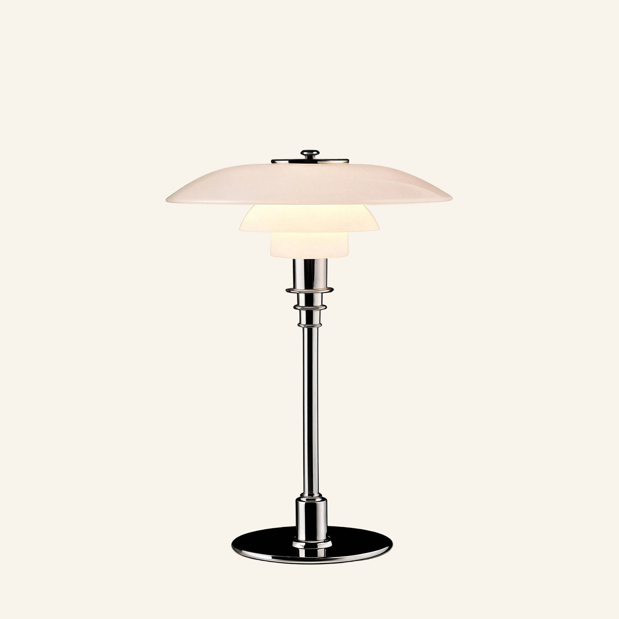 Three-tiered opal glass table lamp with polished chrome stem and round base, shown on cream studio background for bedside use.