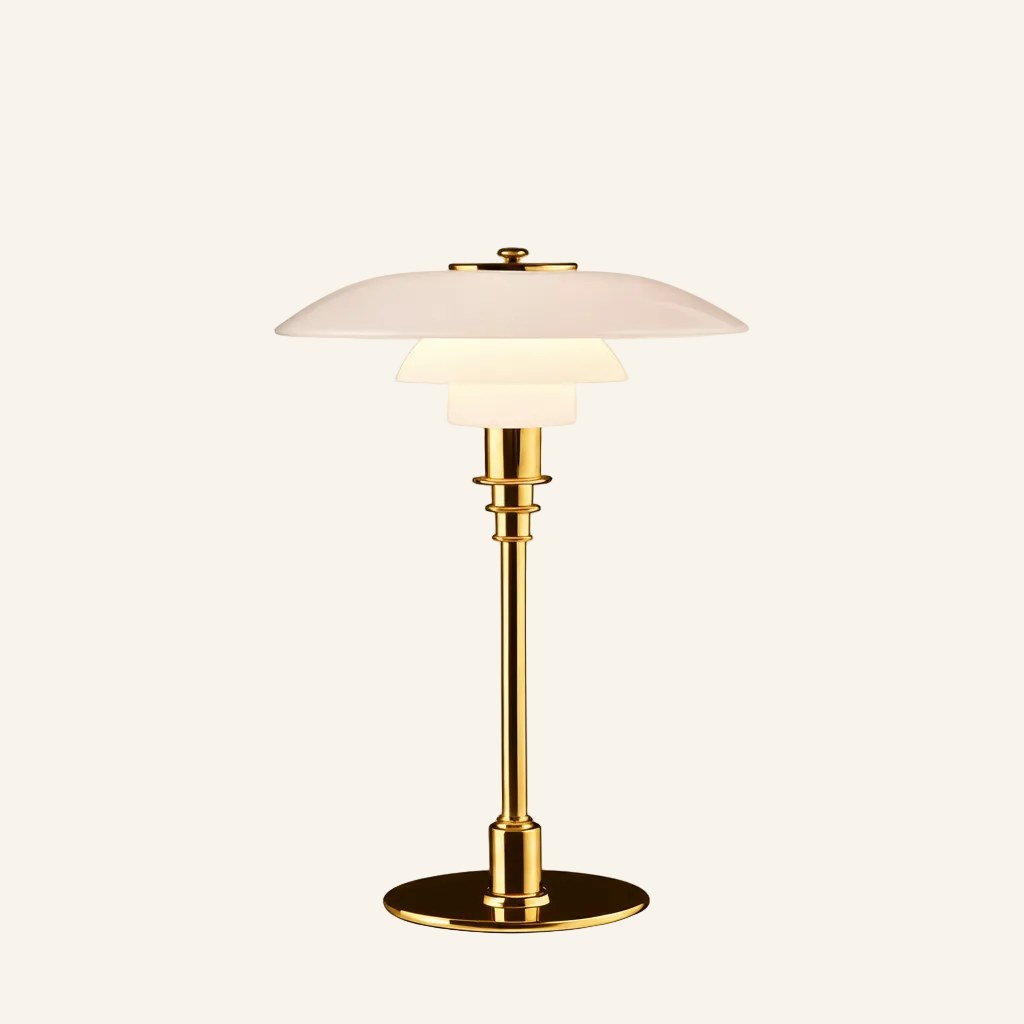 Same tiered opal glass lamp shown with polished brass stem and disc base, warm bedside light against cream backdrop.