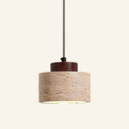 Travertine stone pendant lamp with dark walnut wood cap suspended on a black cord, on cream background.