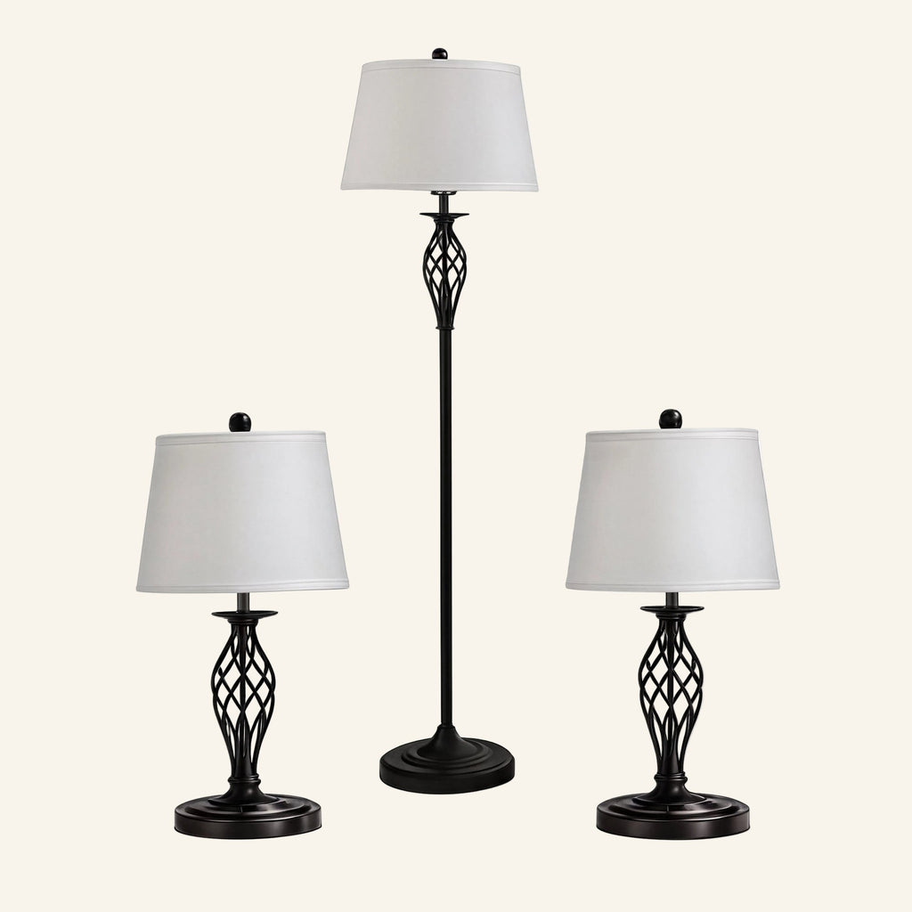 Three-piece black metal lamp set with a tall floor lamp flanked by two matching table lamps, all with white drum shades.