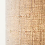 Close-up of the natural beige linen fabric shade revealing its open weave and visible woven seams.